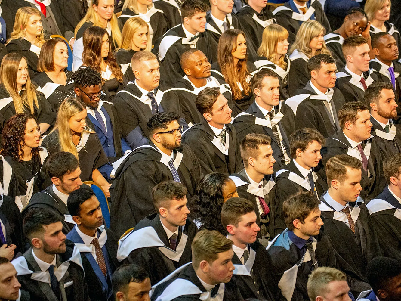 graduates sitting waiting to graduate