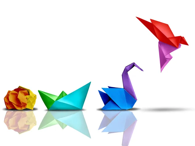 illustration of paper folding progression from ball to flying bird