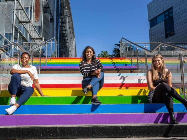 students stat on rainbow painted steps
