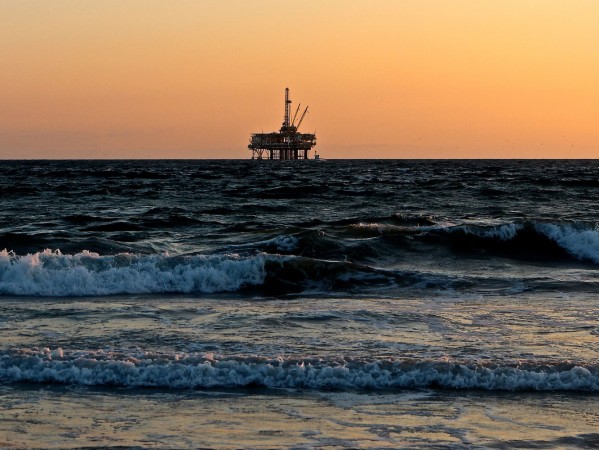 Oil rig in the sea at sunset