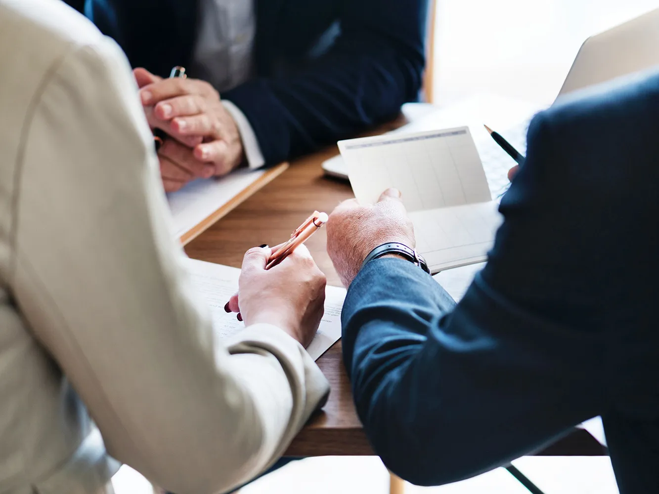 people looking over documents on a table