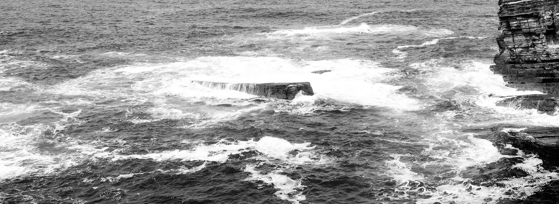Black and white photograph of sea waves in Orkney