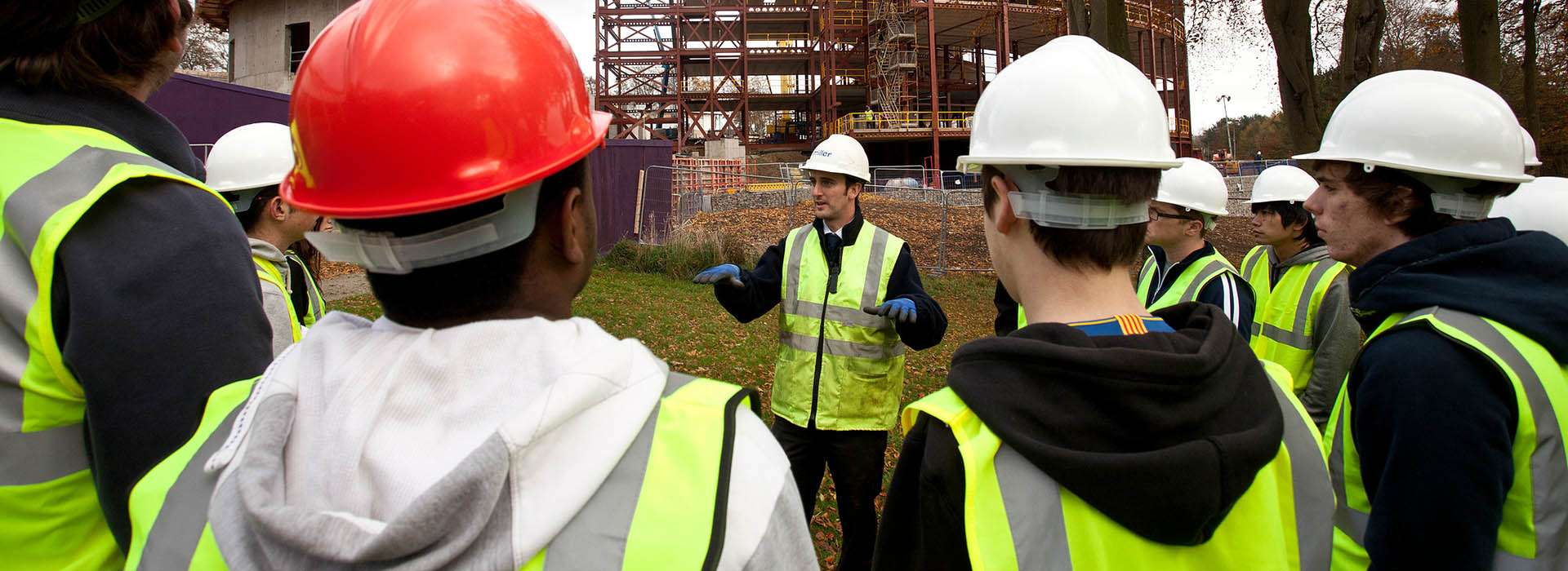 people on a building site wearing high vis and hard hats