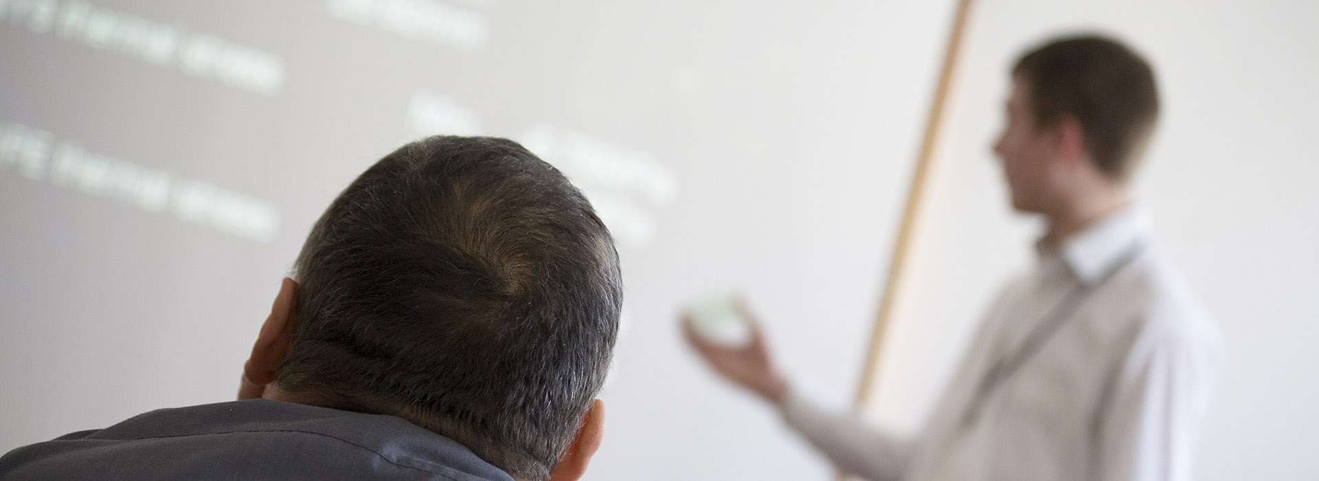 person listening to someone else's presentation