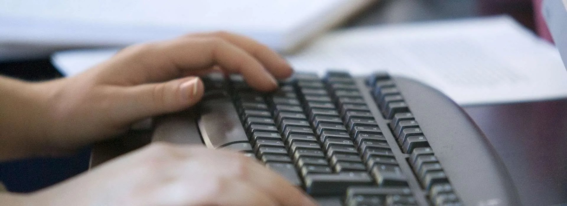 person typing on keyboard