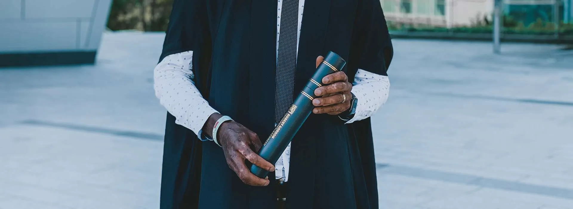Graduate with gown and scroll