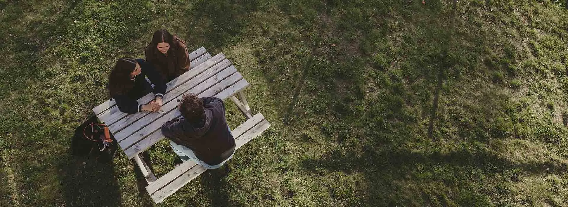 Students sitting at bench pictured from above