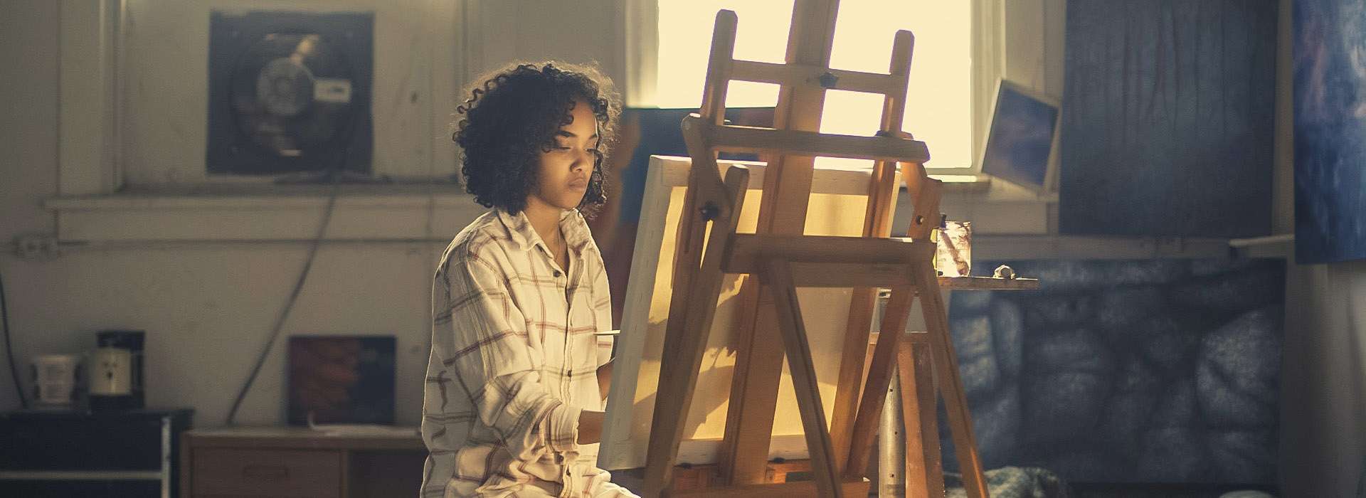 Person painting at an easel