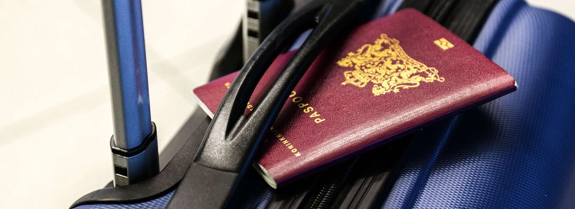 passport sitting on top of suitcase