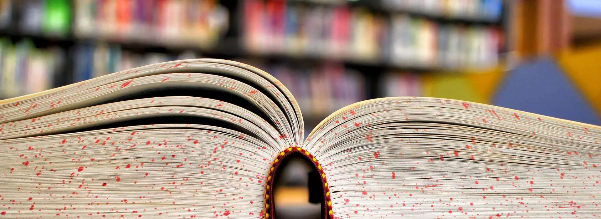 open book in front of shelves