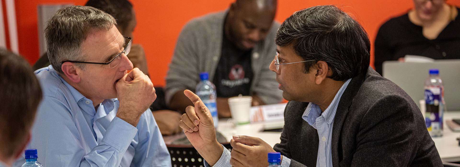 two people in suits having an in depth discussion