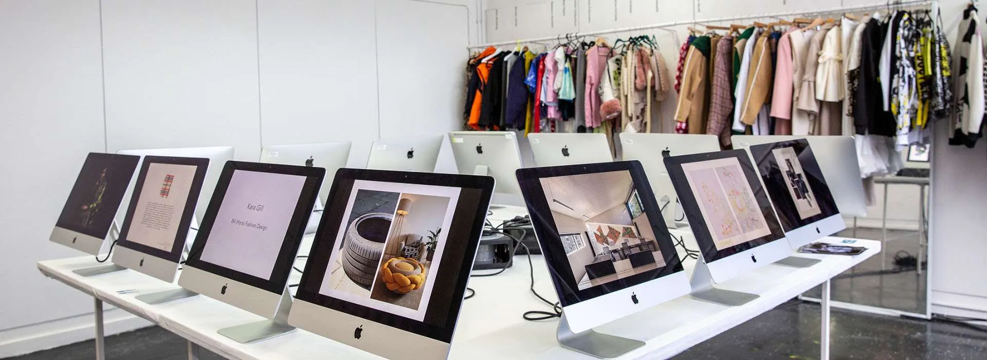 student garments hanging next to computer screens
