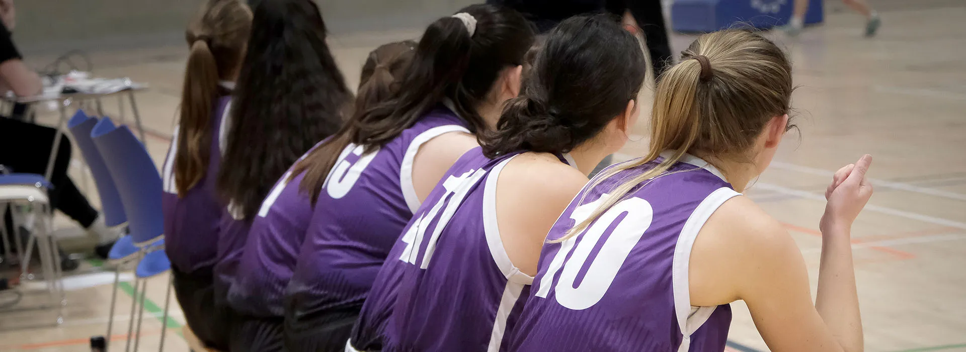 netball players sitting on a bench