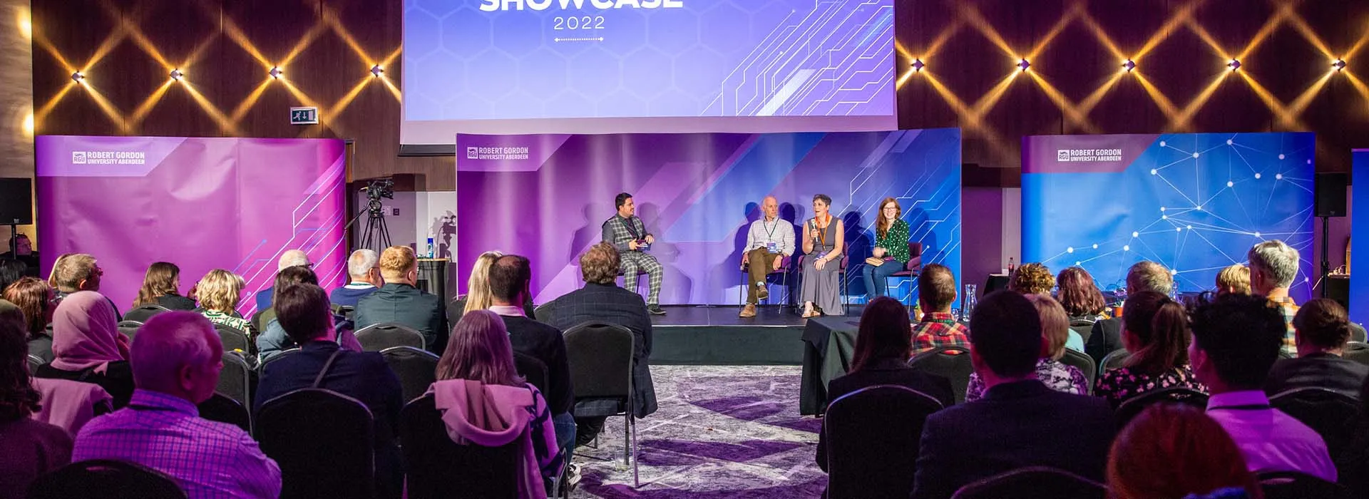 audience listening to a panel at startup showcase event