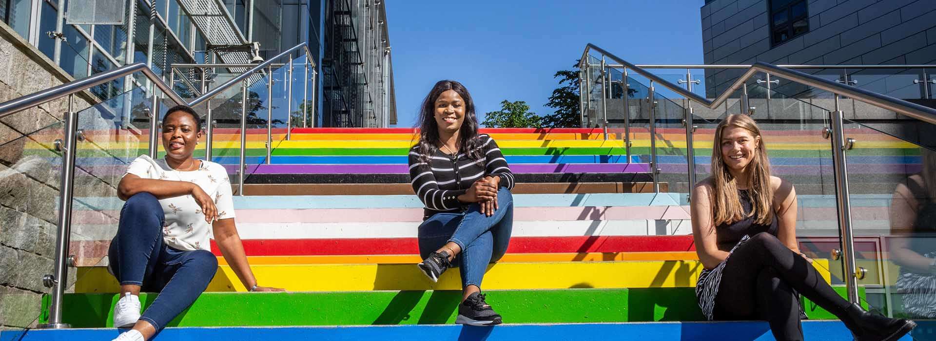 student union presidents sit on the rainbow stairs on campus