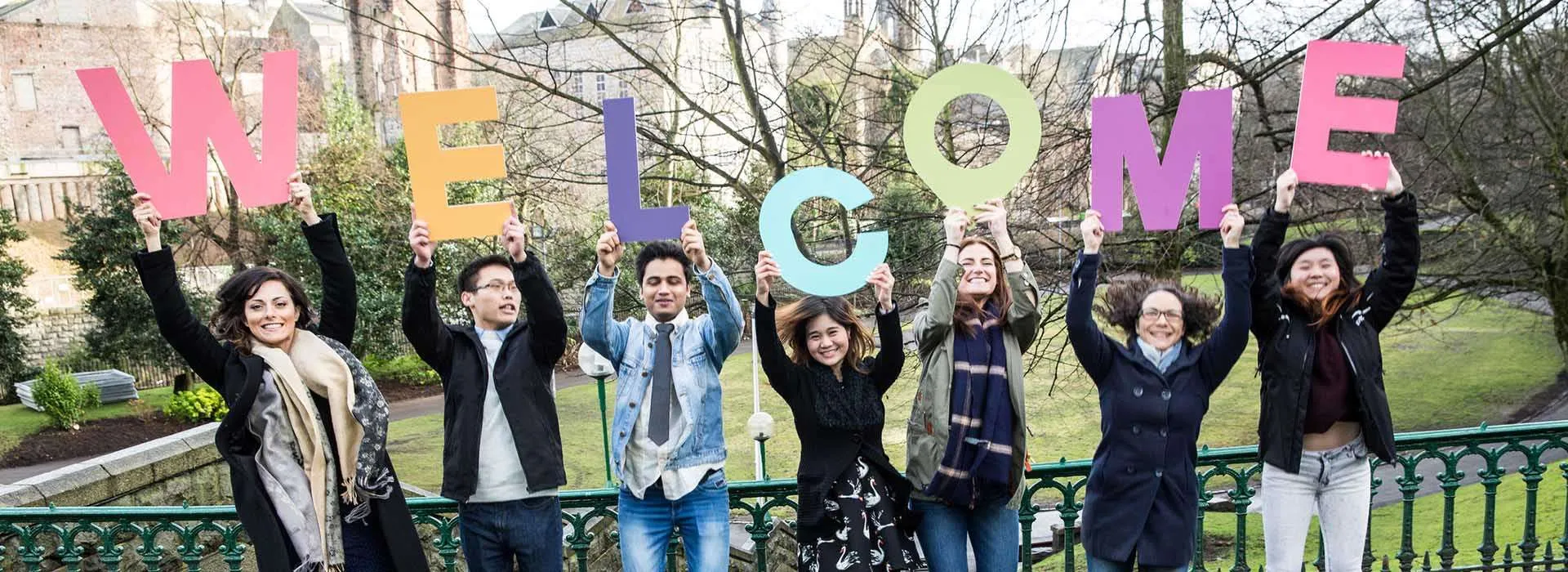 students holding up letters that spell