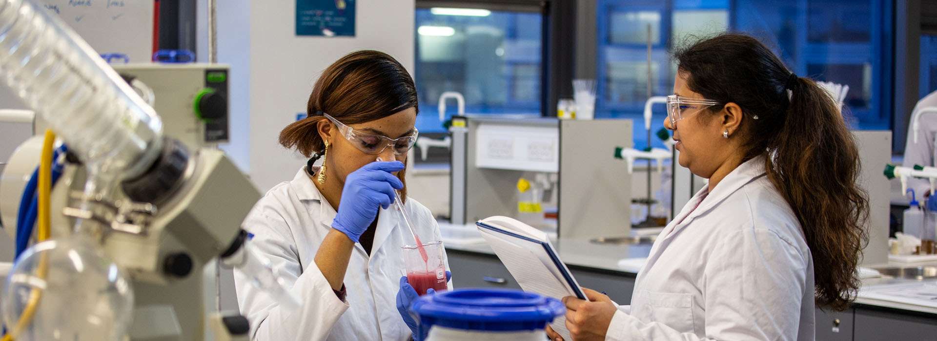 people looking at scientific equipment