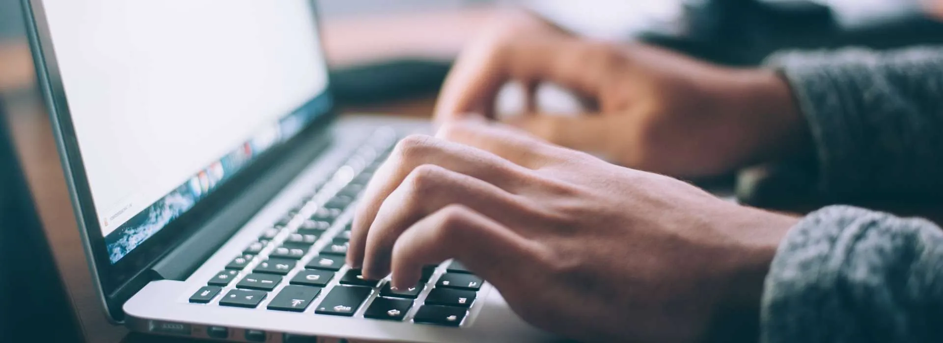 person typing on a laptop