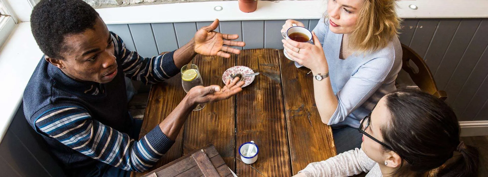 students chatting at a cafe table