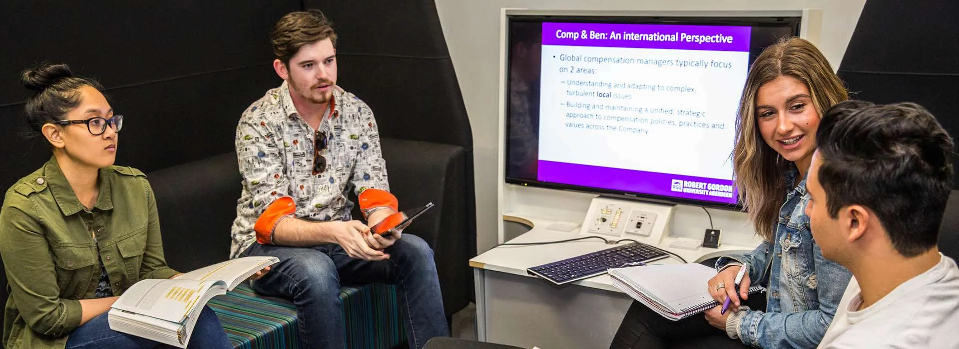 students chatting in a study pod