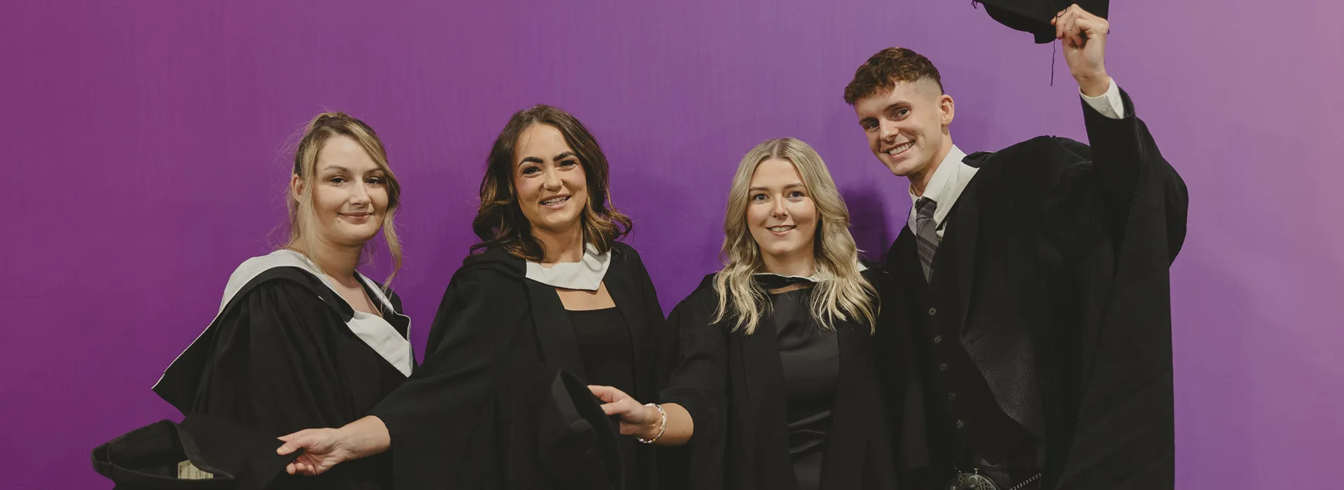 Four RGU graduates pose for a photograph together at P&J Live