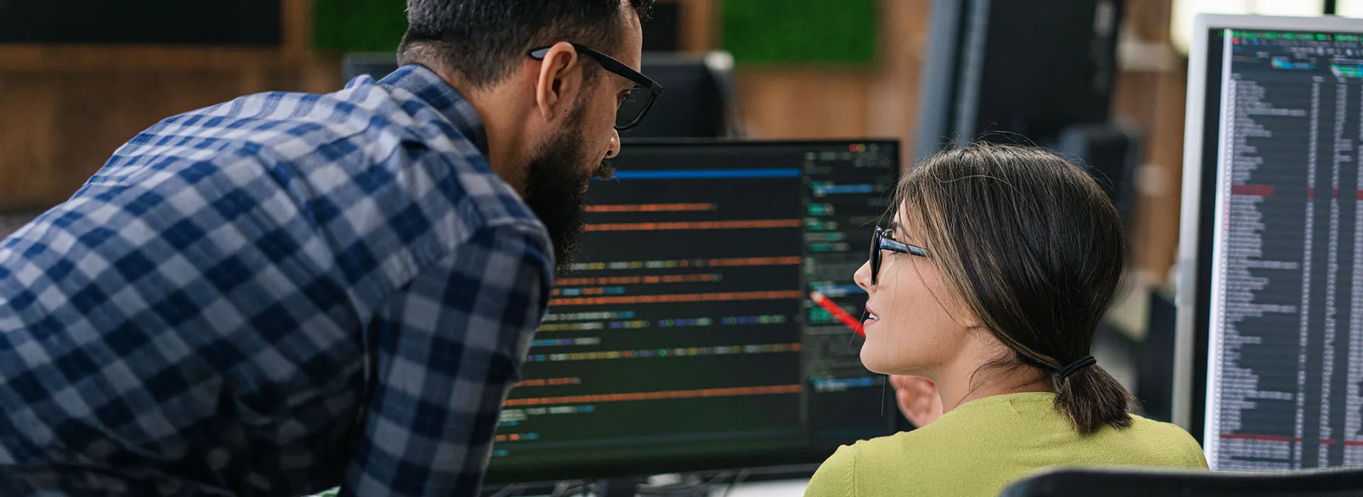 Students looking at a screen with computer code
