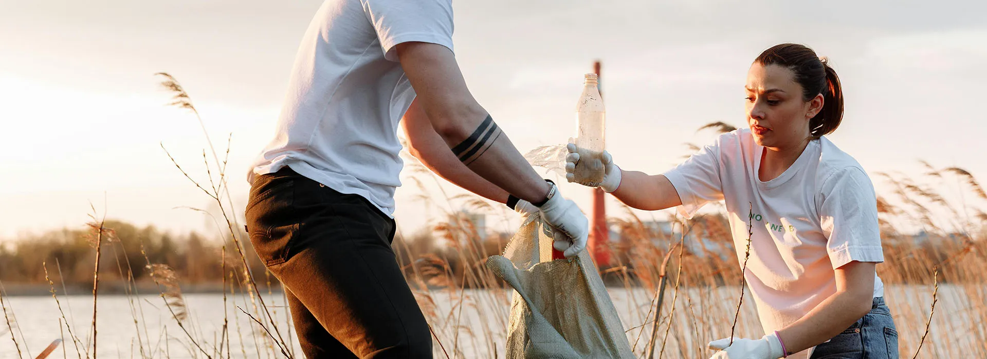 Two people collecting litter