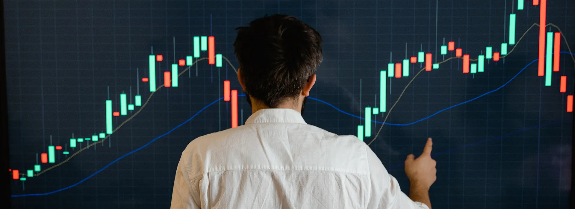 person in front of a large graph on a screen