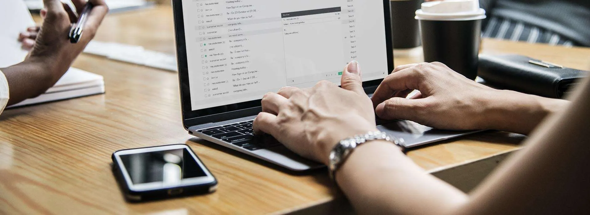 person writing an email on a laptop