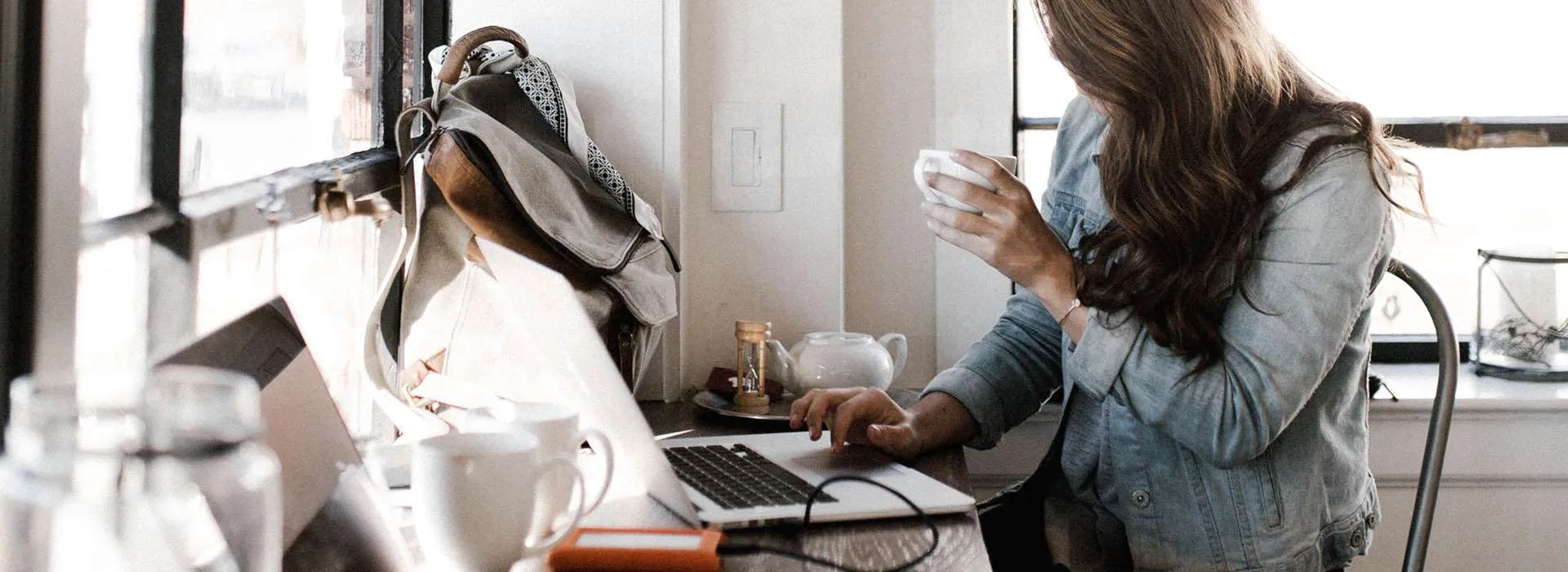 woman with a coffee on a laptop