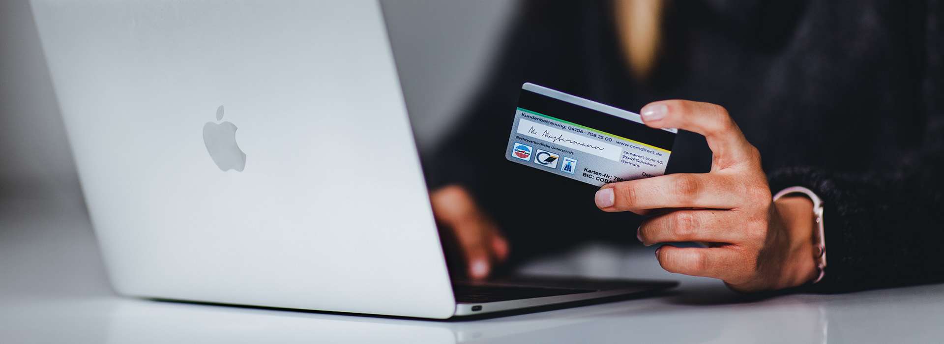 person with a laptop and credit card