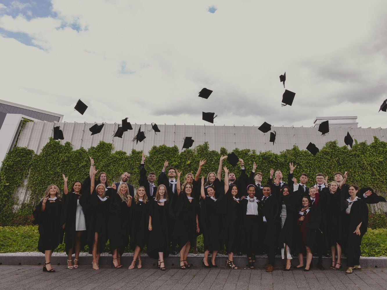 RGU graduates throw their caps into the air.