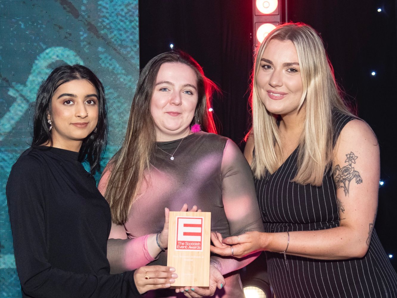 Maryam, Lexy and Jo hold their award together