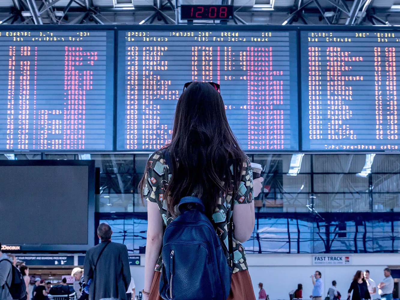 woman looking at train departures board