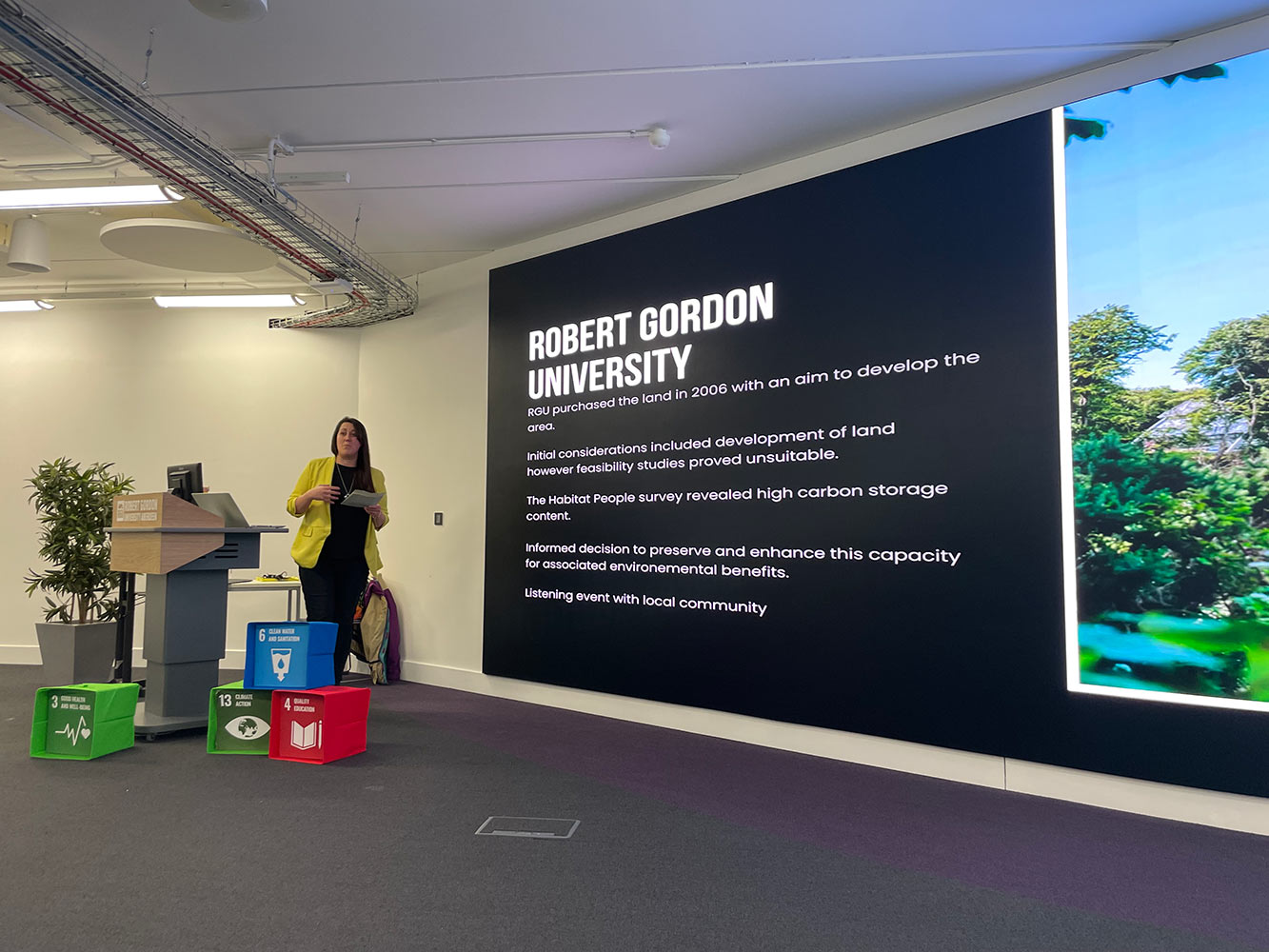 woman giving a presentation about RGU campus
