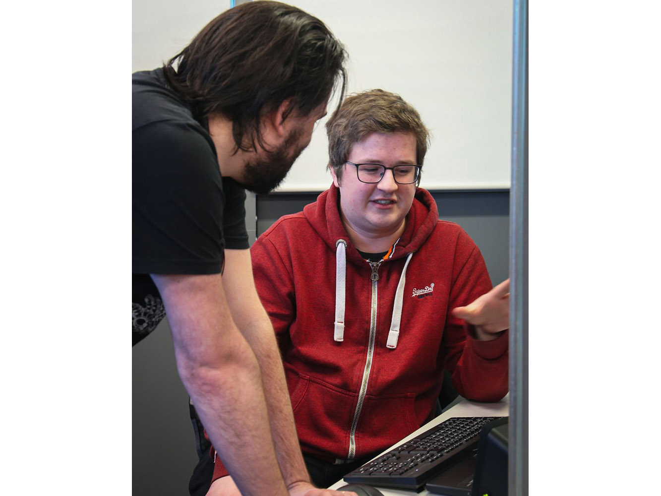 Student talking at desk 