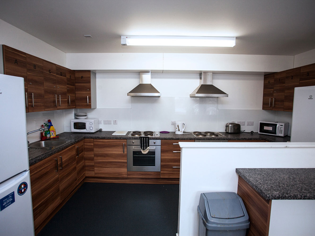 Fitted kitchen with fridge freezer, microwaves and oven