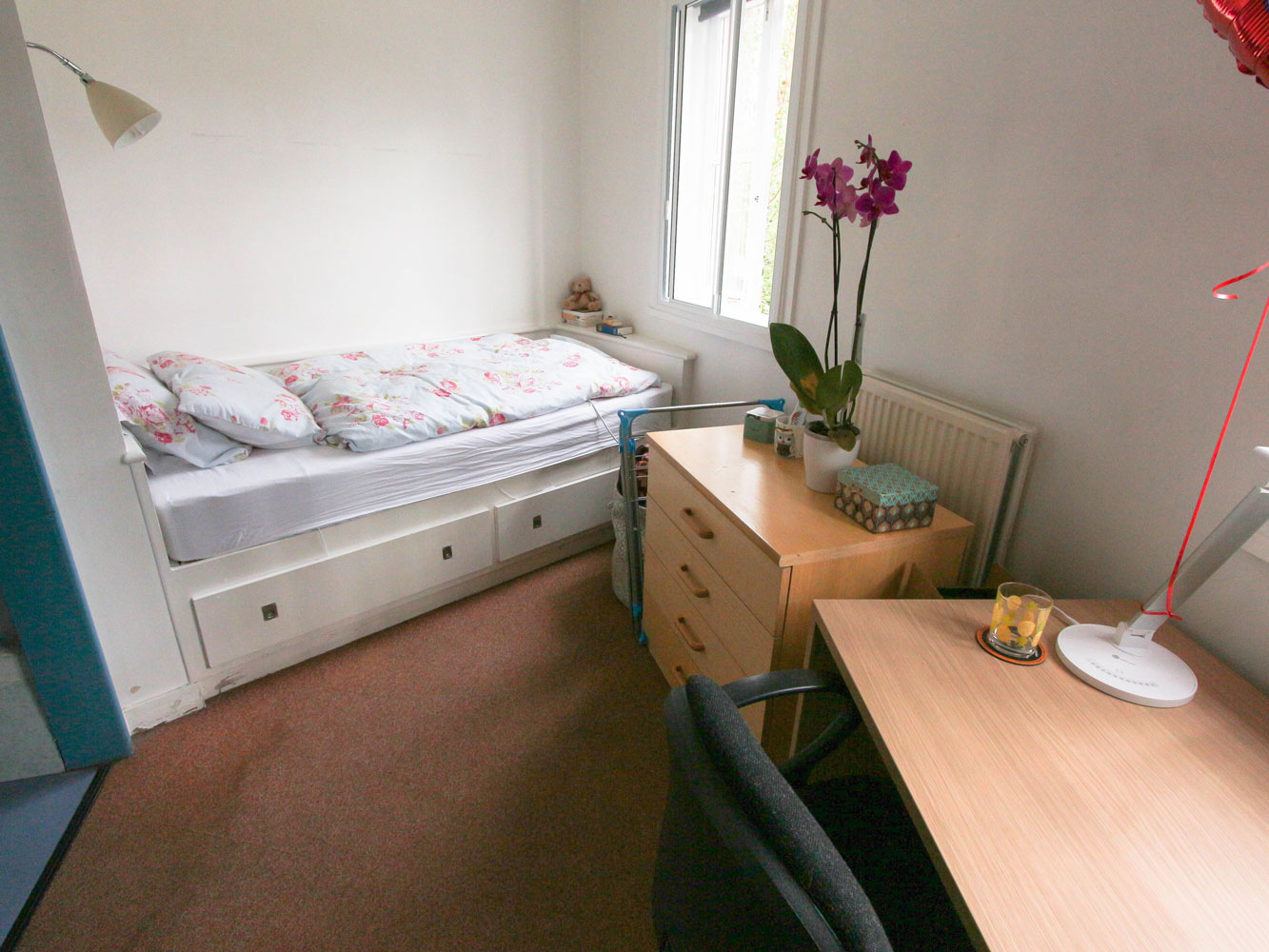 Decorated bedroom with storage, single bed and desk