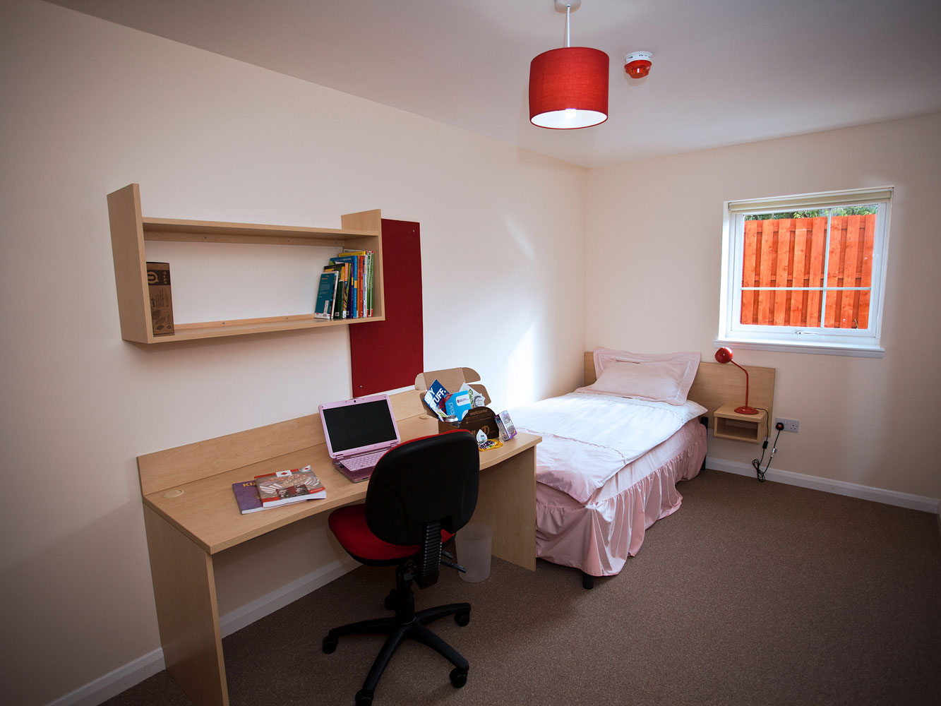 bedroom with single bed, desk and shelving