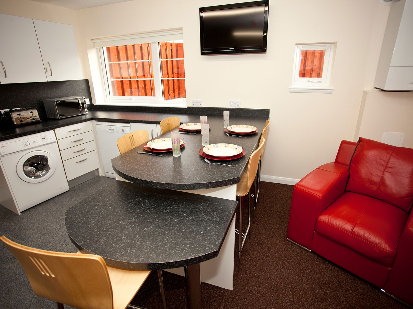 kitchen and lounge area with sofa, dining area and fitted kitchen