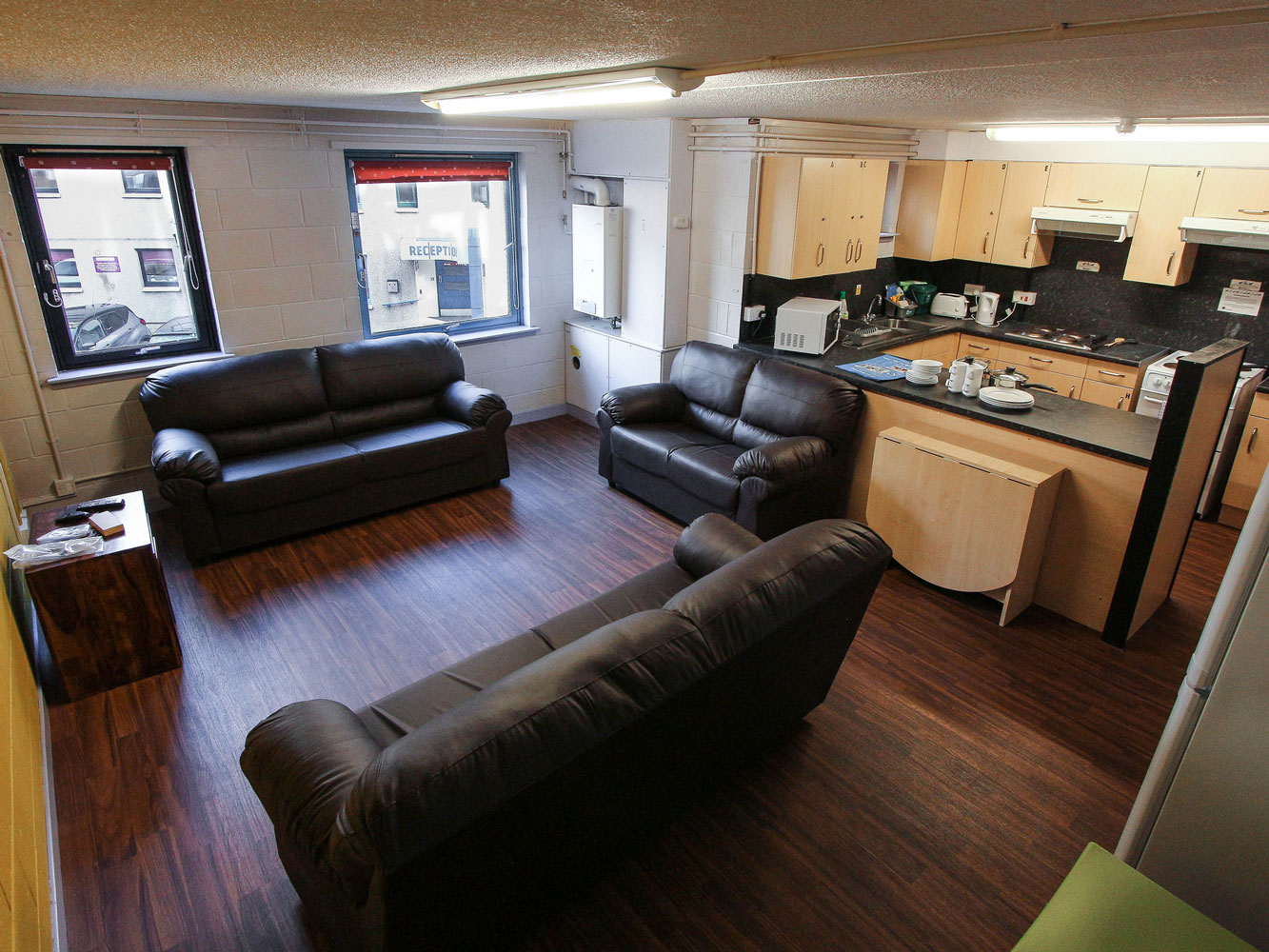 lounge area with three sofas and dining space