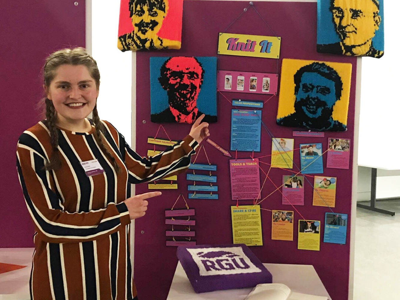 Lucy Fisher with a board of her various knitted portraits and work