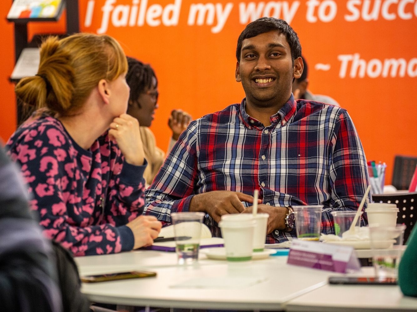 Two people sat at a table taking part in Start Up Accelerator Programme