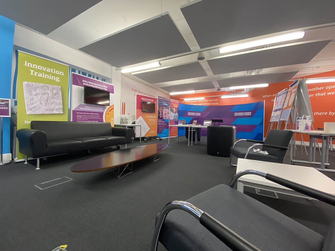 Sitting area with sofas and coffee table within Innovation Station