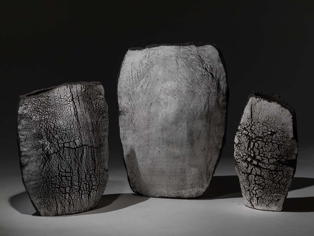 Three ceramic vases shown in black and white