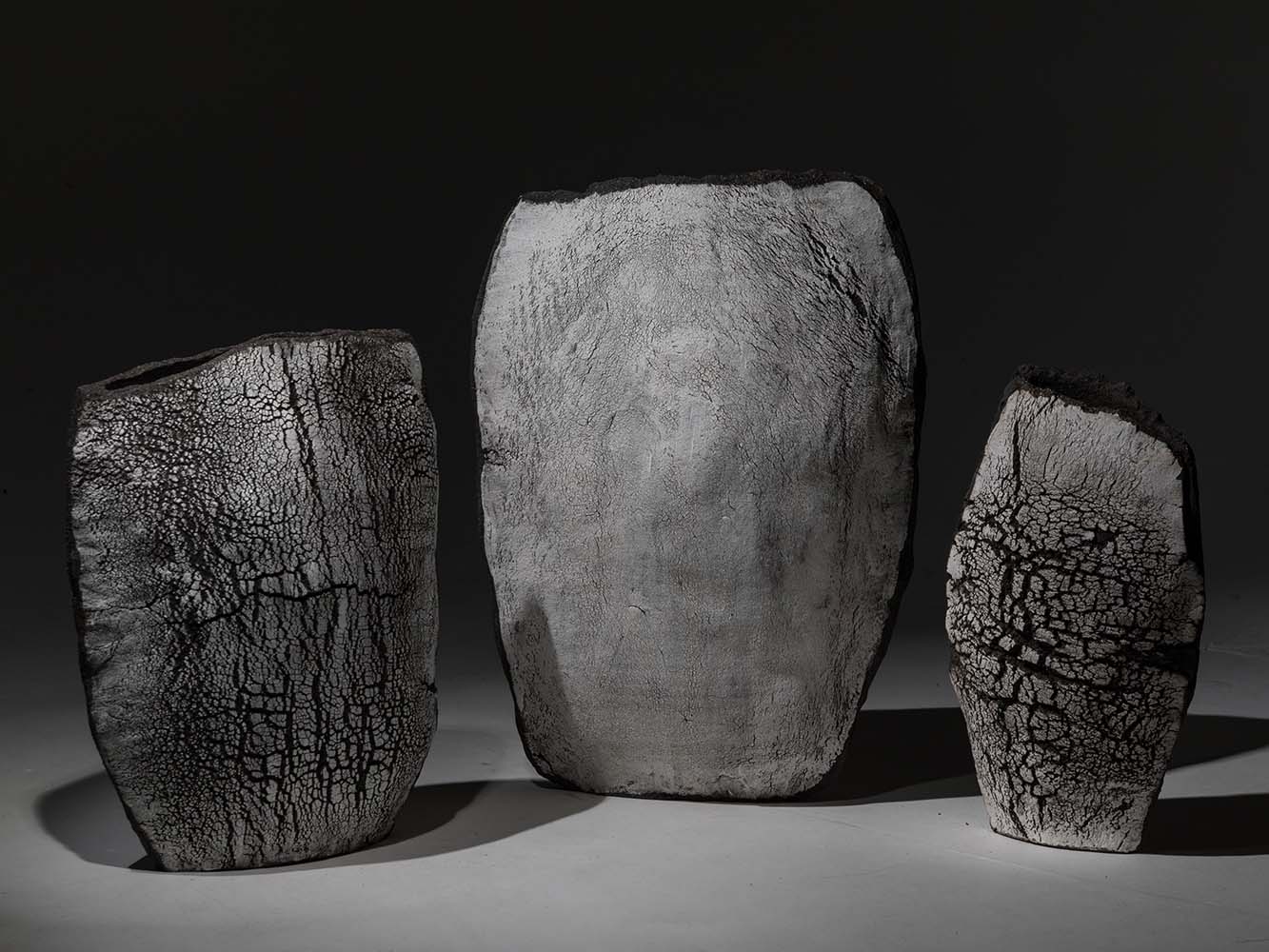 Three ceramic vases shown in black and white