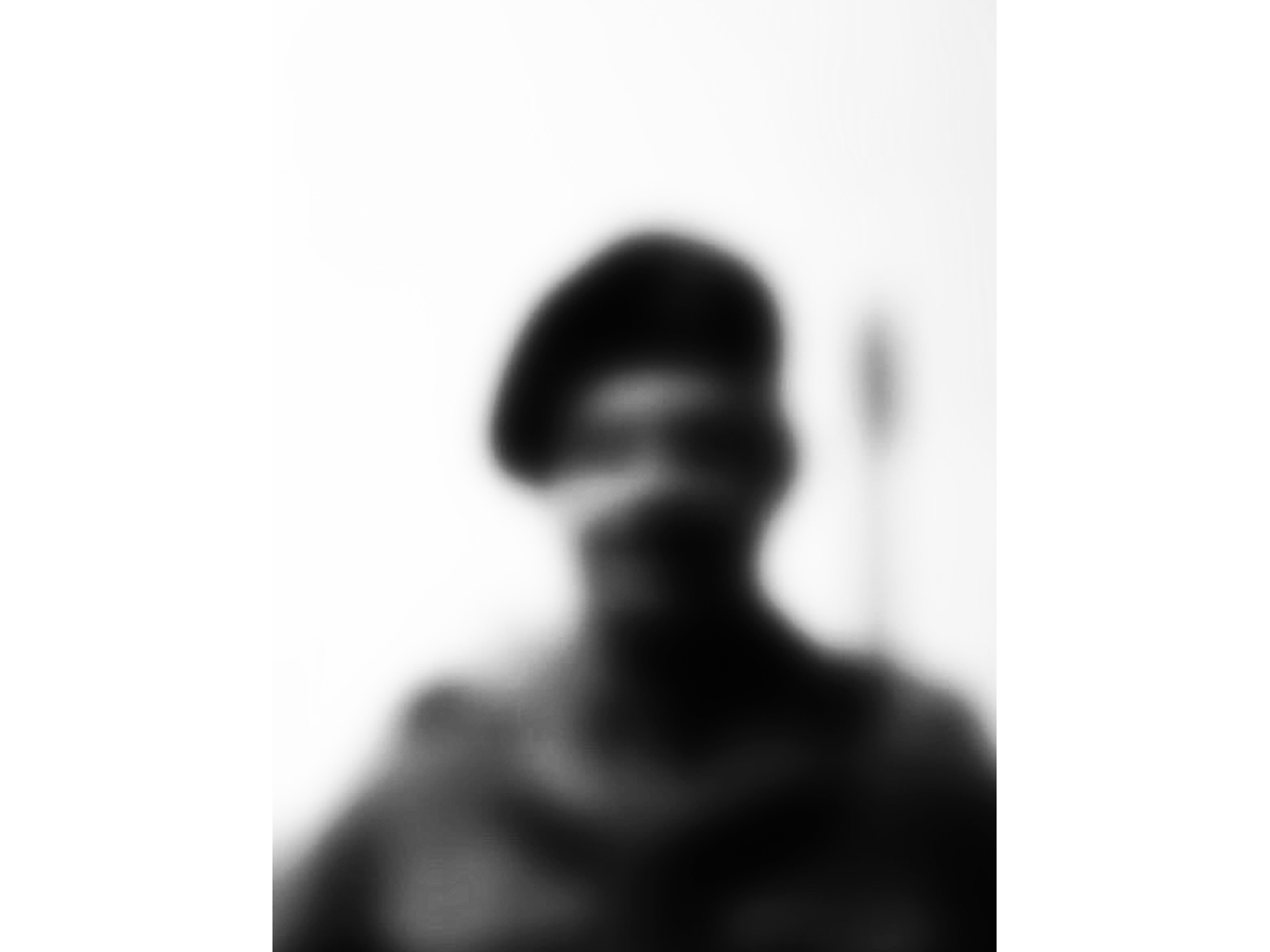 Blurred black and white photography of person wearing a hat