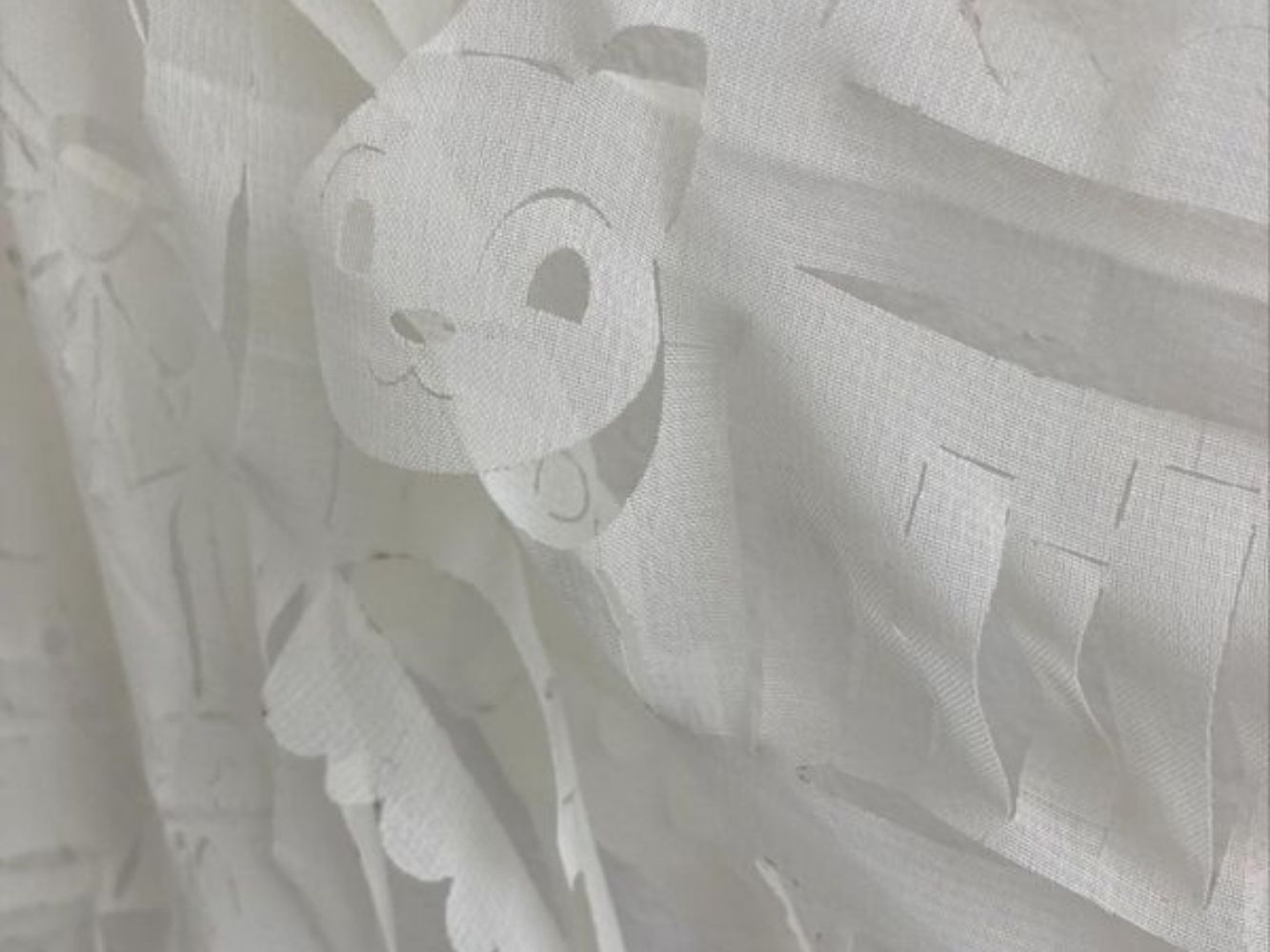 White sheet cut to look like a teddy bear face