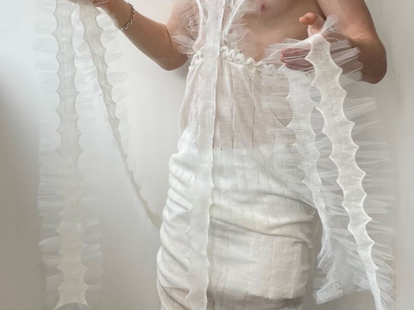 Knitted clothing item worn by model, designed to look like a marine organism