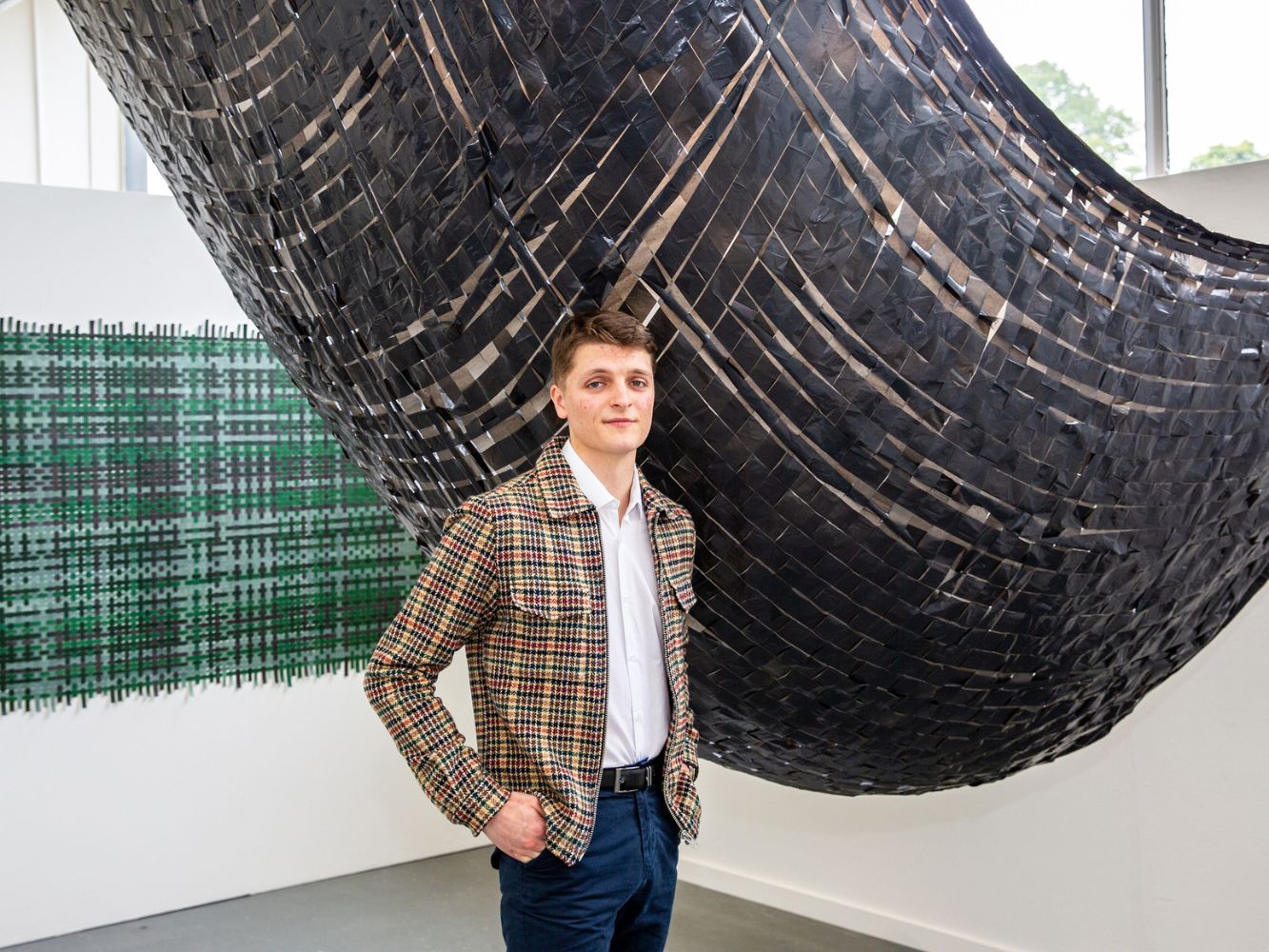 Andrew McFadzean poses with artwork